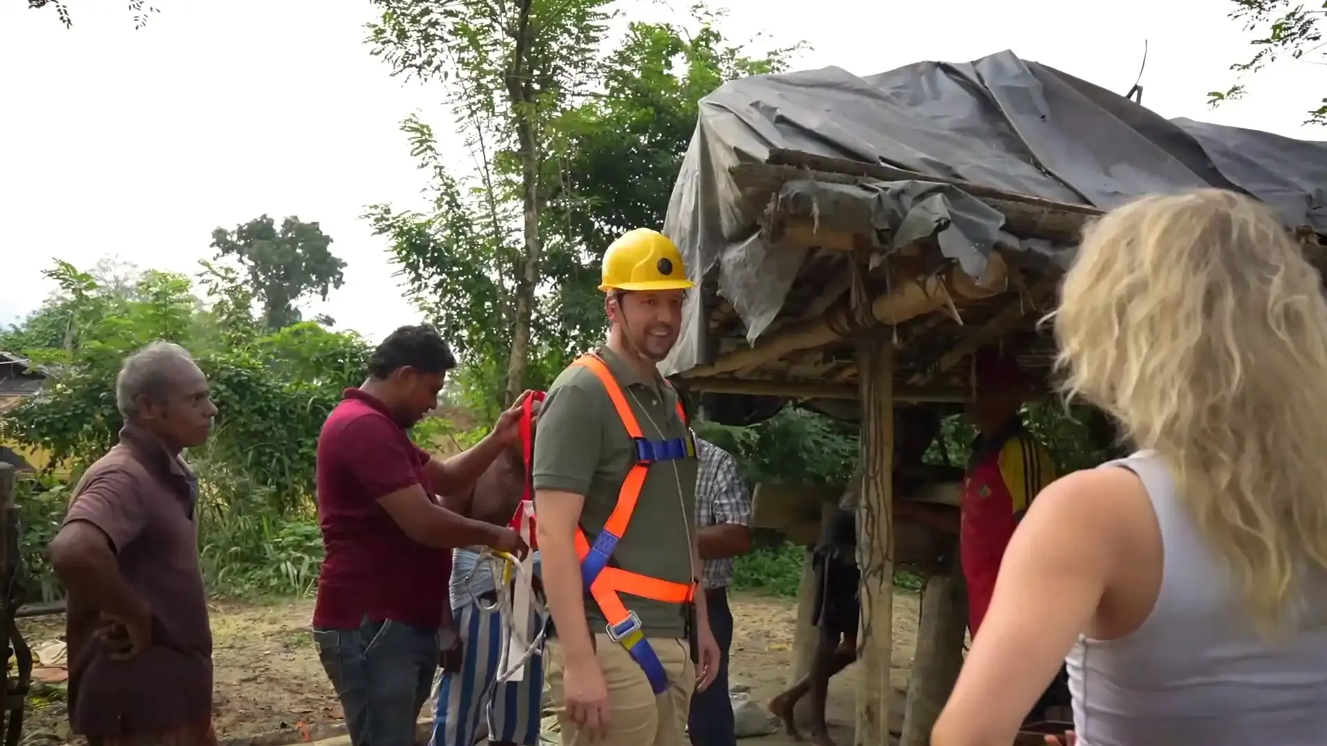 A tourist gets fitted with a safety harness before a gem tour.